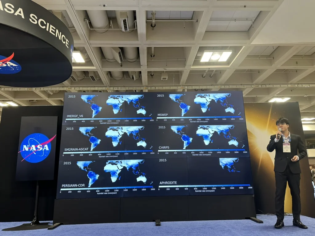 Duc Tran presenting global rainfall maps on a NASA display wall